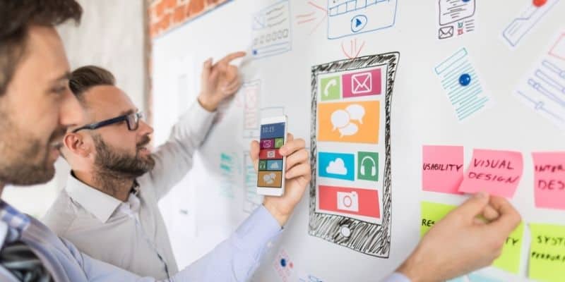 app developer two men with app diagram on white board