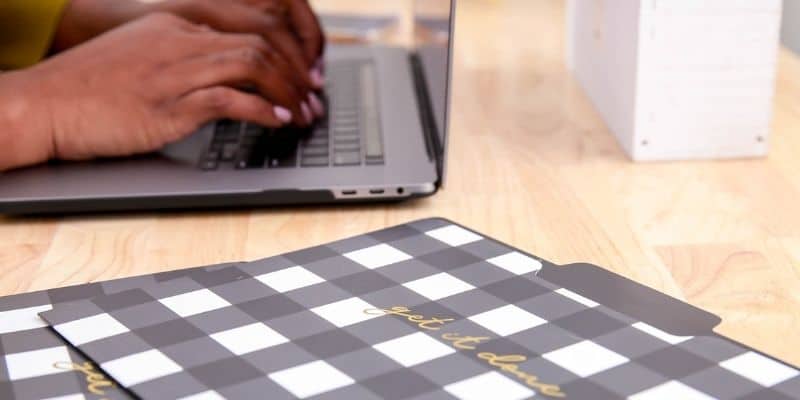 woman in cream sweater working on laptop freelance writing for beginners