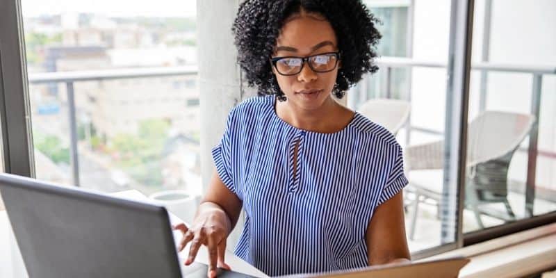 woman on laptop creating a plan to be productive