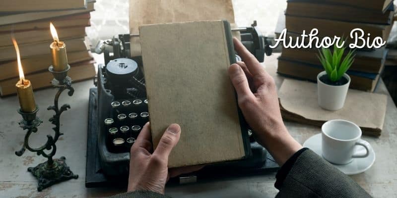 person with typewriter and book