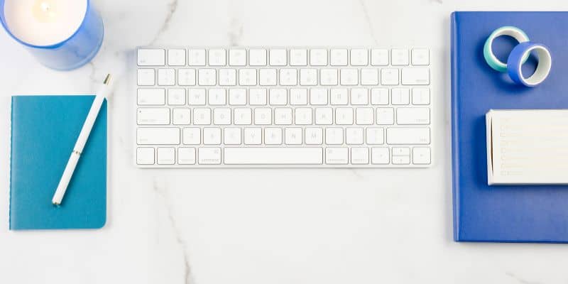 computer keyboard and notebook for working on guest posts