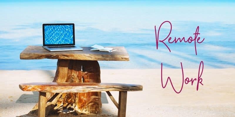 digital nomad podcasts laptop on wooden picnic table on ocean