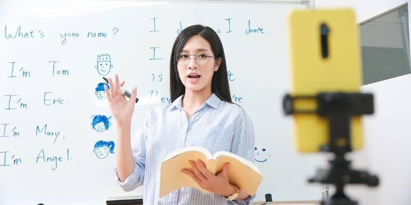 extra money for Christmas woman teaching english with white board