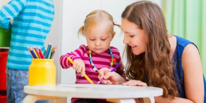 extra money for christmas woman in blue shirt babysitting little girl with blond pig tails