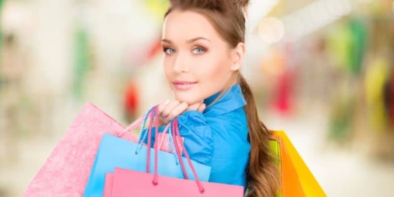 extra money for christmas woman in blue shirt with shopping bags