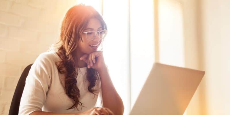 freelance writing niches woman typing a long-form blog post on laptop