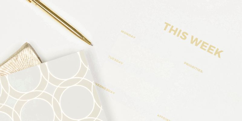 gold pen and a planner for writing your goals and objects for a content repurposing workflow