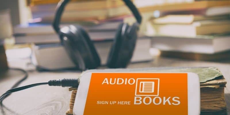 headphones hooked up to smartphone that says sign up for audiobooks