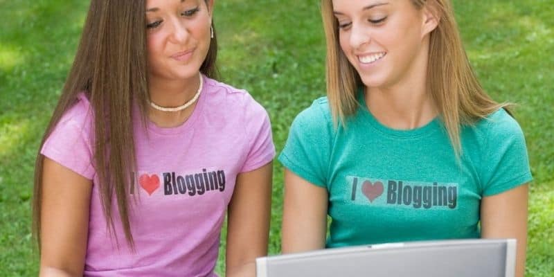 two girls with i love blogging t-shirts on and a laptop