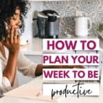 woman on her cellphone working on a laptop in the kitchen