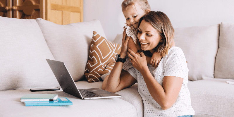 mom and playing with daughter while she works on her summer content ideas