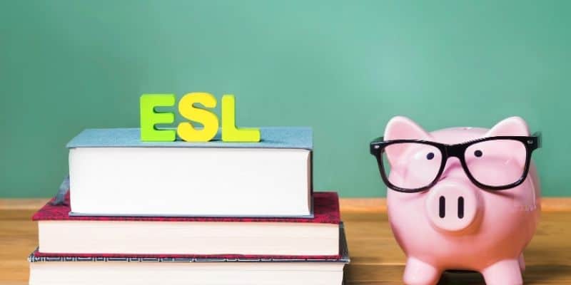 pink pig with glasses on beside stack of books