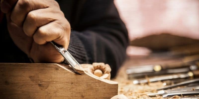 person carving wood