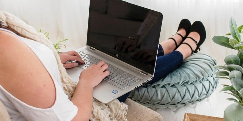 popular copywriter typing on a laptop about niching down as a writer