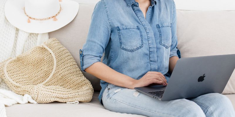 solopreneur in denim working on a project on her laptop