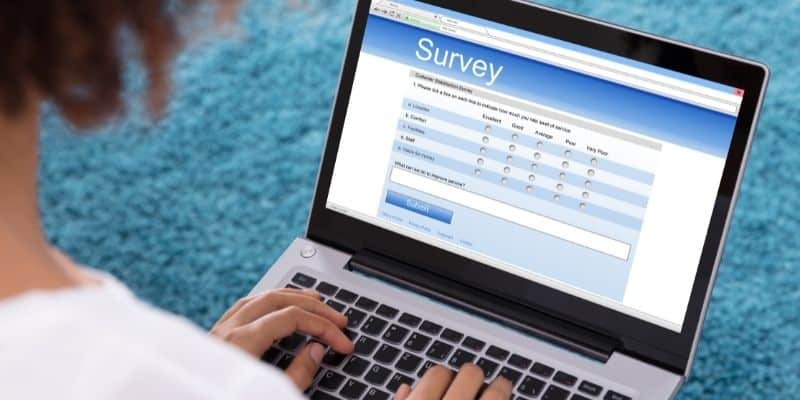 surveys extra money for Christmas woman taking survey on laptop