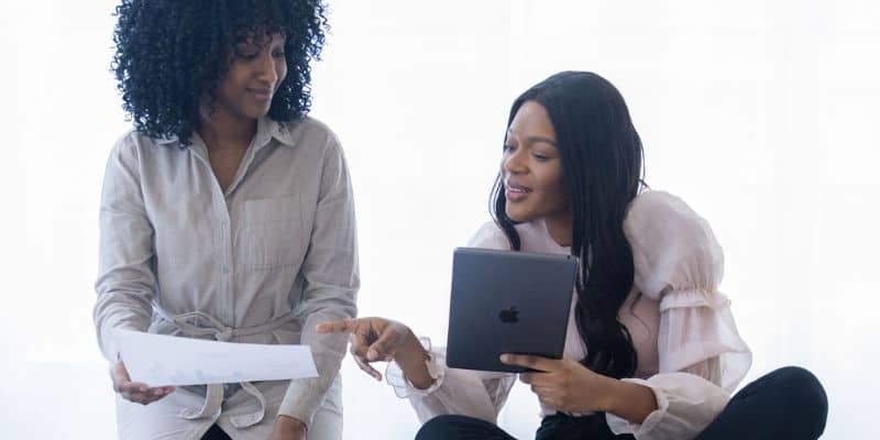 two women on tablet working and collaborating