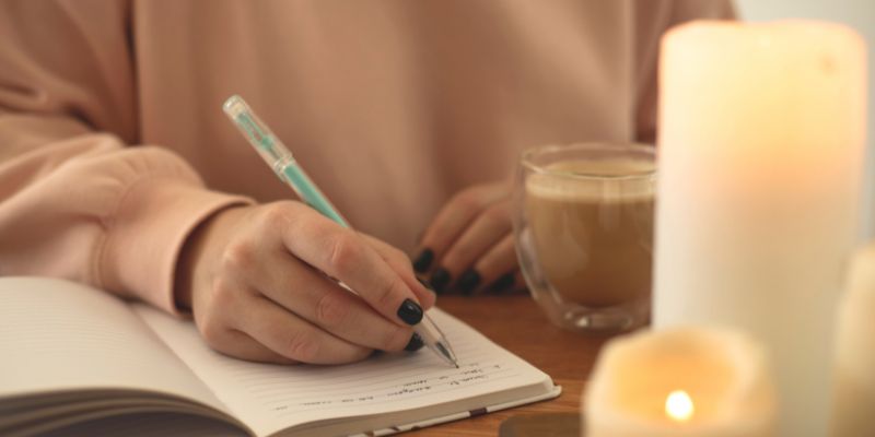 woman journaling to help combat imposter syndrome