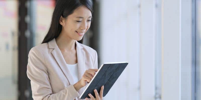 woman smiling with tablet in hand