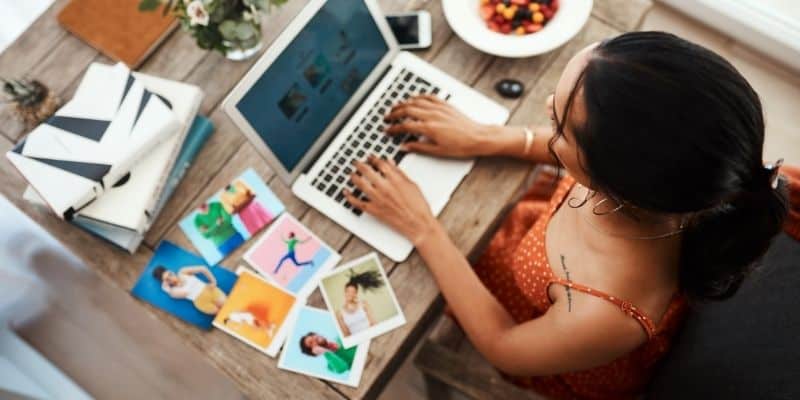 woman typing a blog post on laptop