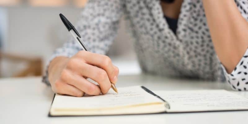 woman with pen and notebook