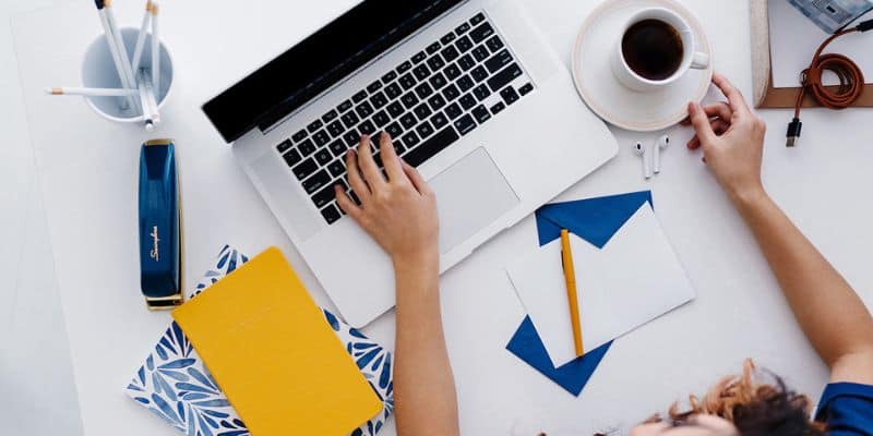 women working on an seo plan on her laptop with coffee